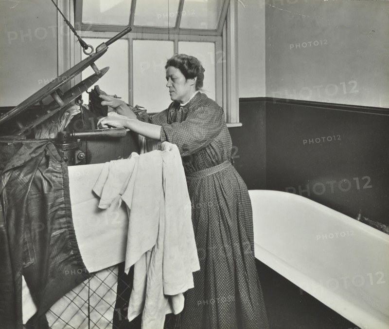 Nurse using a steriliser in the bathroom at Chaucer Cleansing Station, London, 1911. Artist: Unknown.