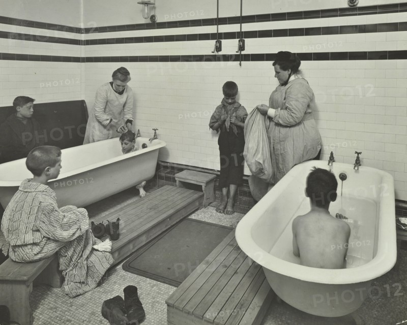 Attendants bathing boys at the Sun Court Cleansing Station, London, 1914. Artist: Unknown.