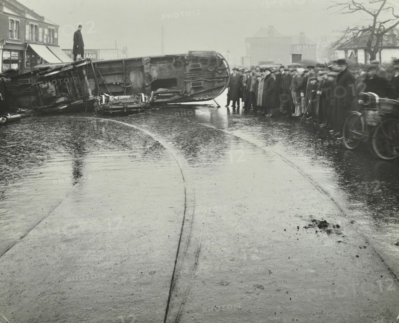 Overturned electric tram and onlookers, London, 1913. Artist: Unknown.
