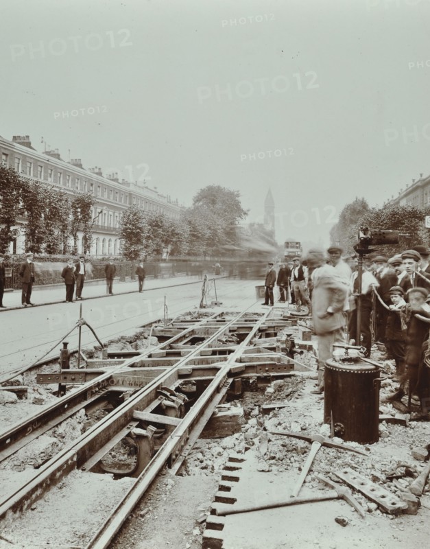 Workmen extending tramlines, Brixton Road, London, 1907. Artist: Unknown.