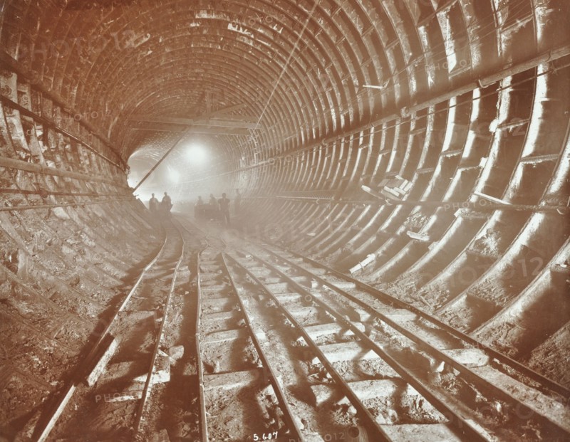 Men pushing railway trucks along the Rotherhithe Tunnel, Stepney, London, June 1907. Artist: Unknown.