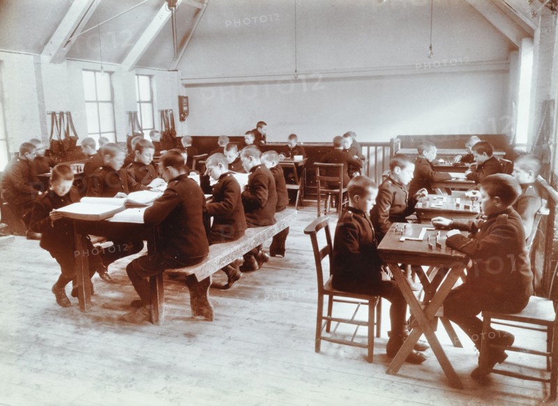 Boys playing dominoes and reading at the Boys Home Industrial School, London, 1900. Artist: Unknown.