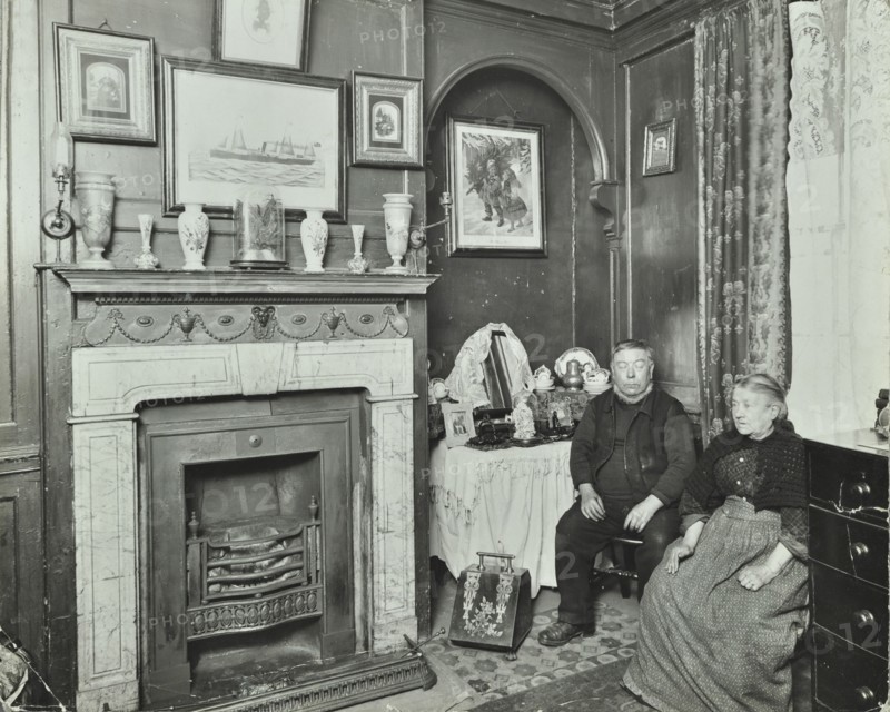 Elderly couple in Victorian interior, Albury Street, Deptford, London, 1911. Artist: Unknown.