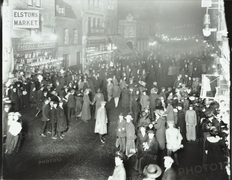 Crowds in Deptford High Street shopping after dark, London, 1913. Artist: Unknown.