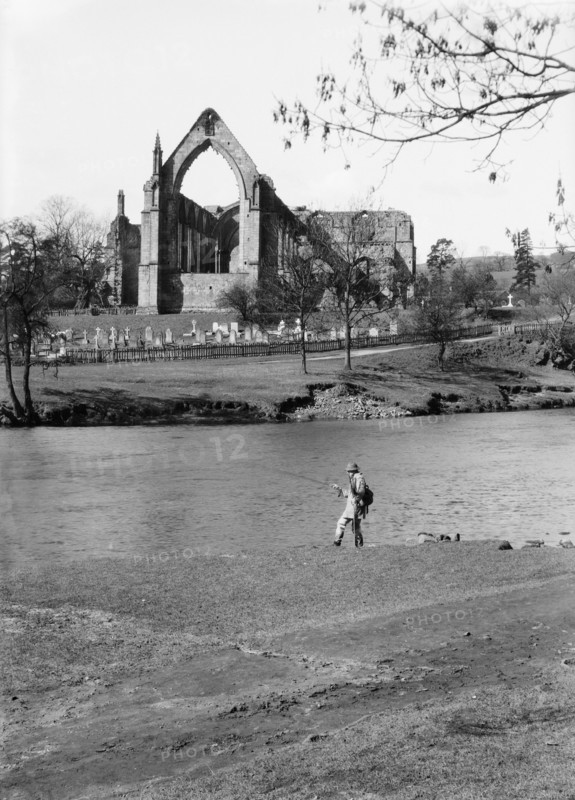 A fisherman on the River Wharfe in front of the ruins of Bolton Priory, North Yorkshire, 1940