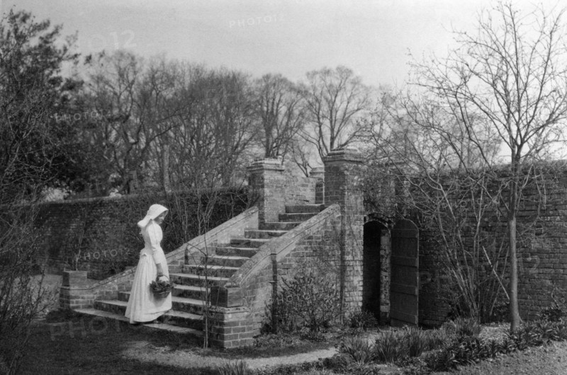 Woman standing at the base of the garden steps, Ufton Court, Ufton Nervet, Berkshire. c1901