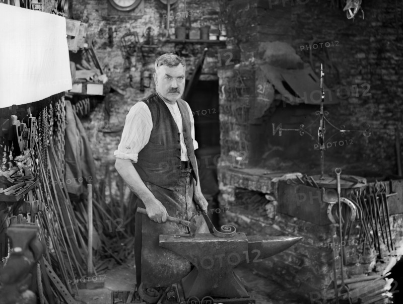 Mr Jefferies at work in the forge, Southrop, Cotswolds, Gloucestershire, 1938