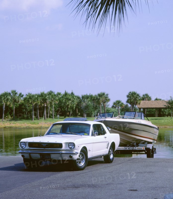 1967 Ford Mustang towing a boat. Artist: Unknown.