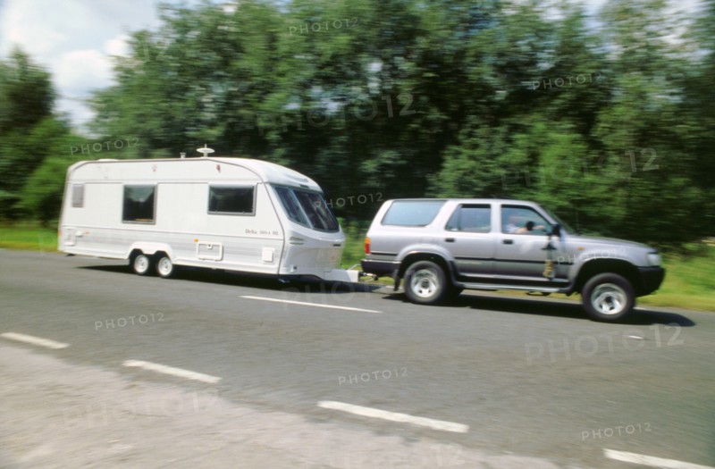 1995 Toyota Landcruiser towing large caravan at speed. Artist: Unknown.