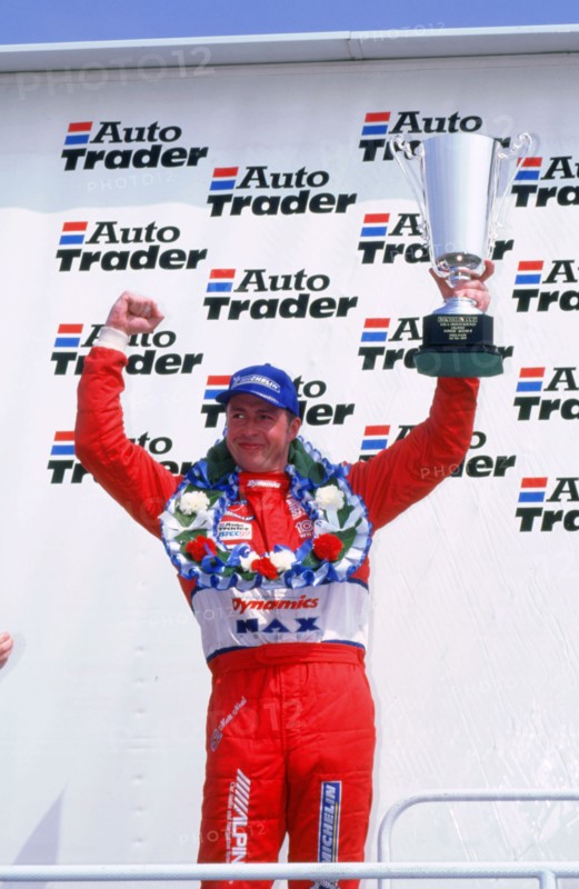 Matt Neal, Nissan driver, celebrates victory, 1999 British touring cars. Artist: Unknown.