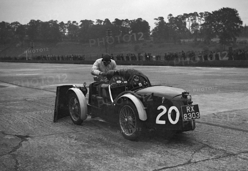 Mechanic making adjustments to a MG C type, Brooklands. Artist: Bill Brunell.
