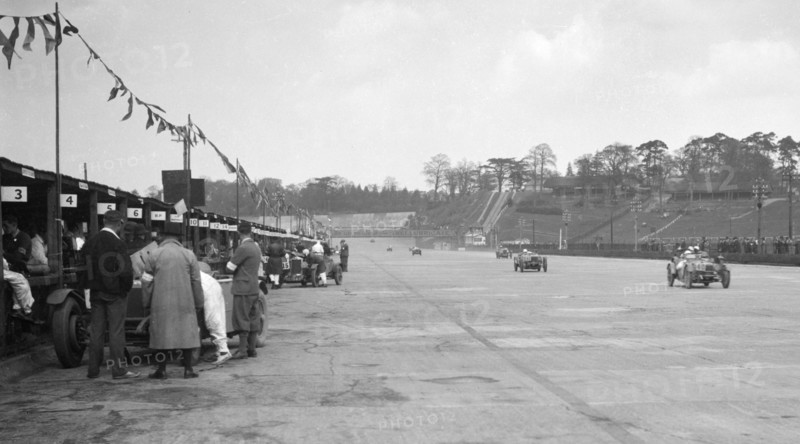 Invicta leading a Riley 9 Brooklands in the JCC Double Twelve race, Brooklands, 8/9 May 1931. Artist: Bill Brunell.