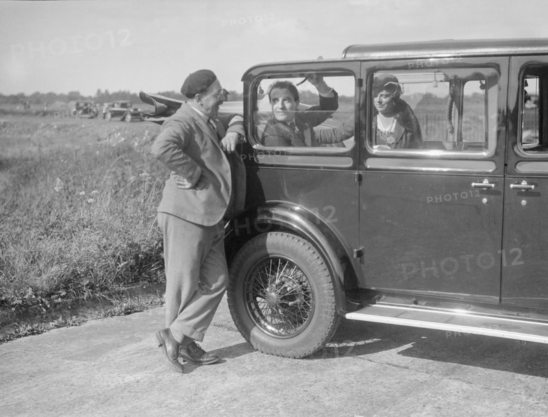 Hugh McConnell, Sammy Davis and Mrs Davis with an Austin 20/6 landaulette at Brooklands, 1931. Artist: Bill Brunell.
