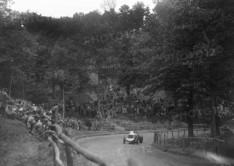 Raymond Mays' Vauxhall-Villiers competing in the Shelsley Walsh Speed Hill Climb, Worcestershire. Artist: Bill Brunell.