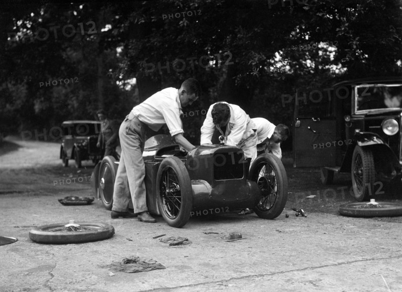 Mechanics working on Leon Cushman's Austin 7 racer for a speed record attempt, Brooklands, 1931. Artist: Bill Brunell.