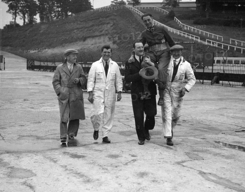 Leon Cushman being carried aloft after making a successful speed record attempt, Brooklands, 1931. Artist: Bill Brunell.