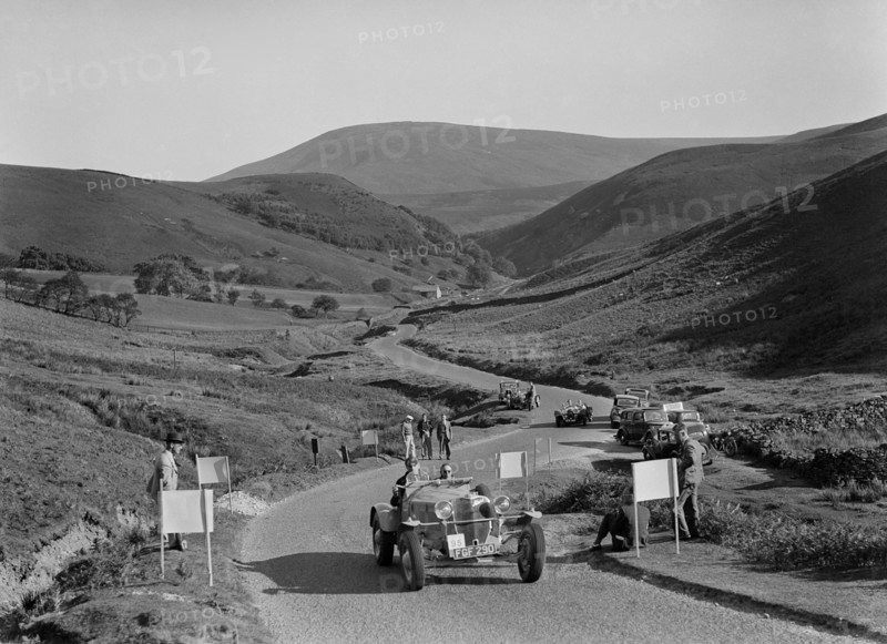 K Hutchison's winning Allard Special leading R Fielding's Jaguar SS at the Blackpool Rally, 1939. Artist: Bill Brunell.