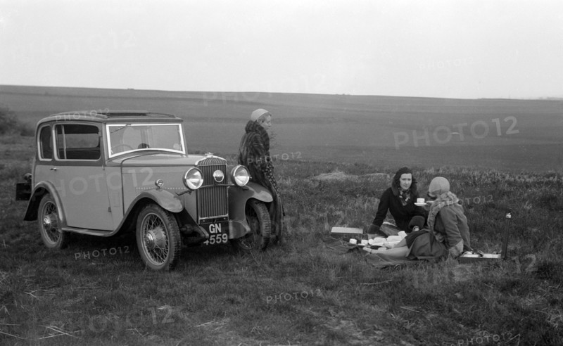 Three women having a picnic during a road test of a Triumph Scorpion, 1931. Artist: Bill Brunell.