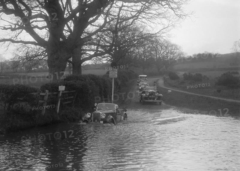 972 cc Singer Le Mans driving through water during a motoring trial, 1936. Artist: Bill Brunell.