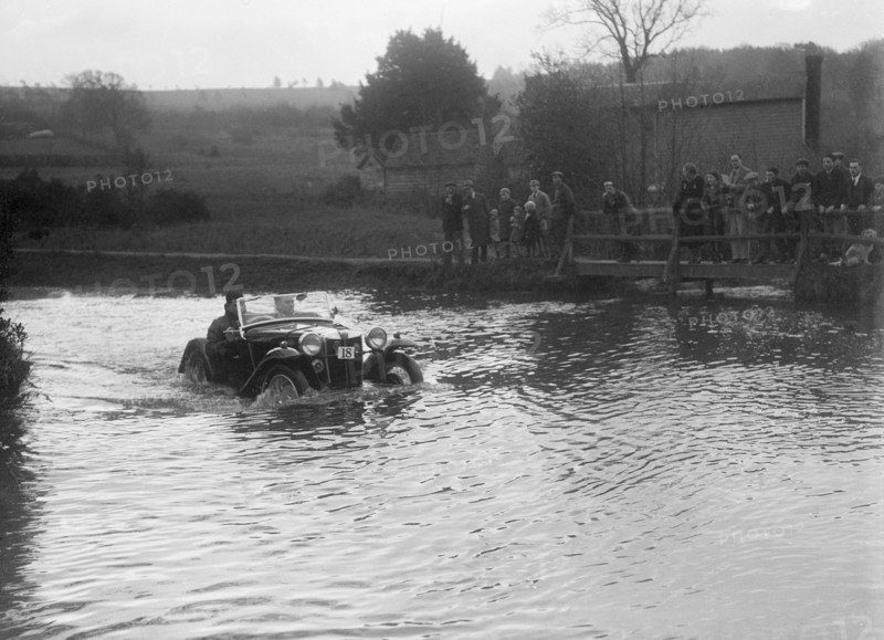 MG PA driving through a ford during a motoring trial, 1936. Artist: Bill Brunell.
