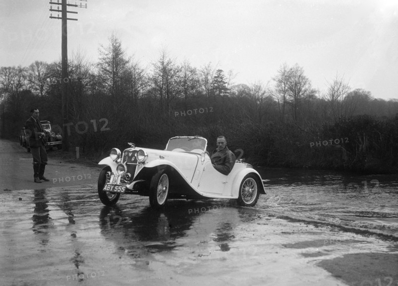 972 cc Singer Le Mans driving through a ford during a motoring trial, 1936. Artist: Bill Brunell.