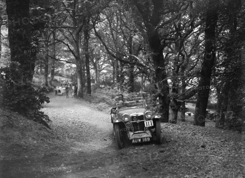 MG Magna competing in the B&HMC Brighton-Beer Trial, Fingle Bridge Hill, Devon, 1934. Artist: Bill Brunell.