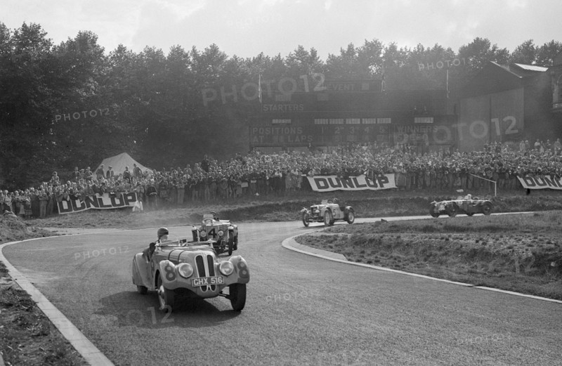 LG Johnson's Frazer-Nash BMW 328 leading two MG PBs, Imperial Trophy, Crystal Palace, 1939. Artist: Bill Brunell.