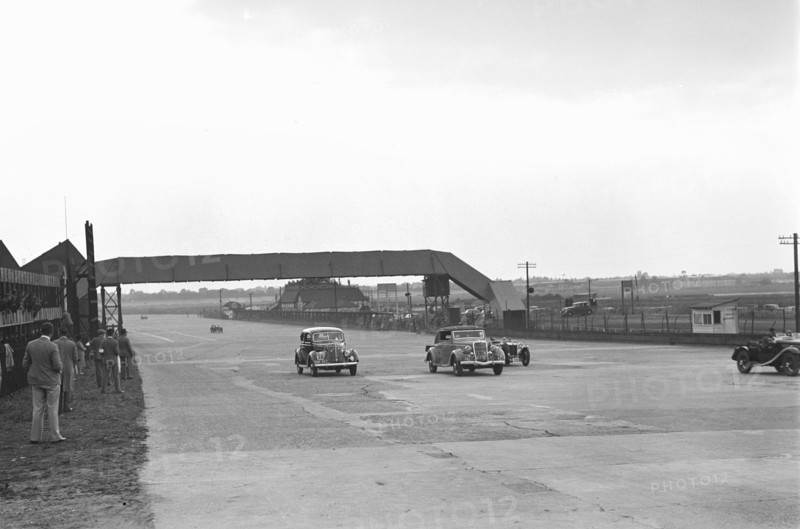 Two Ford V8s and a MG PB at the MCC Members Day, Brooklands, 1938 or 1939. Artist: Bill Brunell.