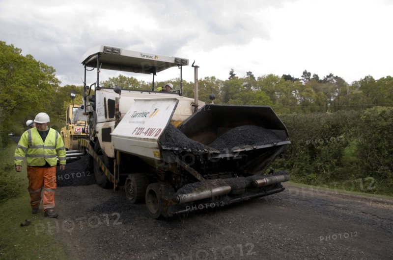 Road resurfacing work repairing potholes Artist: Unknown.