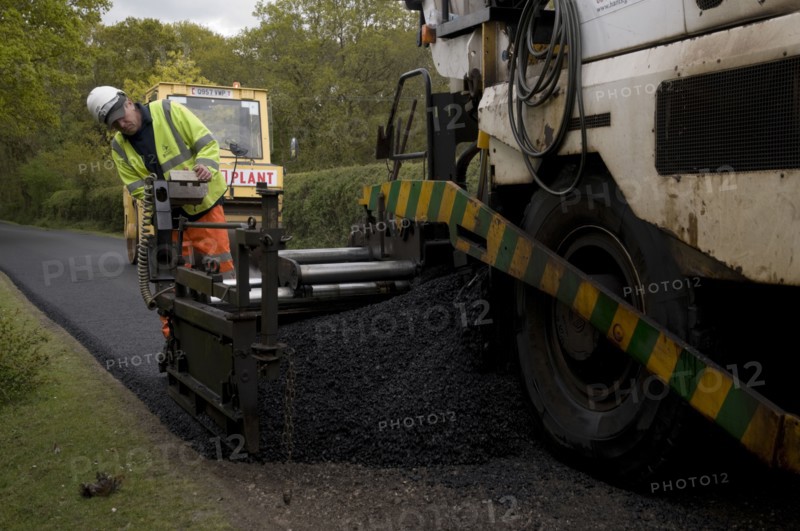 Road resurfacing work repairing potholes Artist: Unknown.