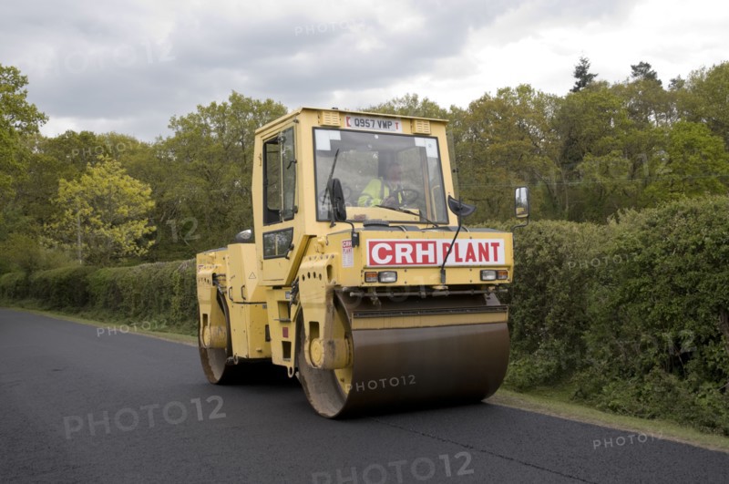 Road resurfacing work repairing potholes Artist: Unknown.
