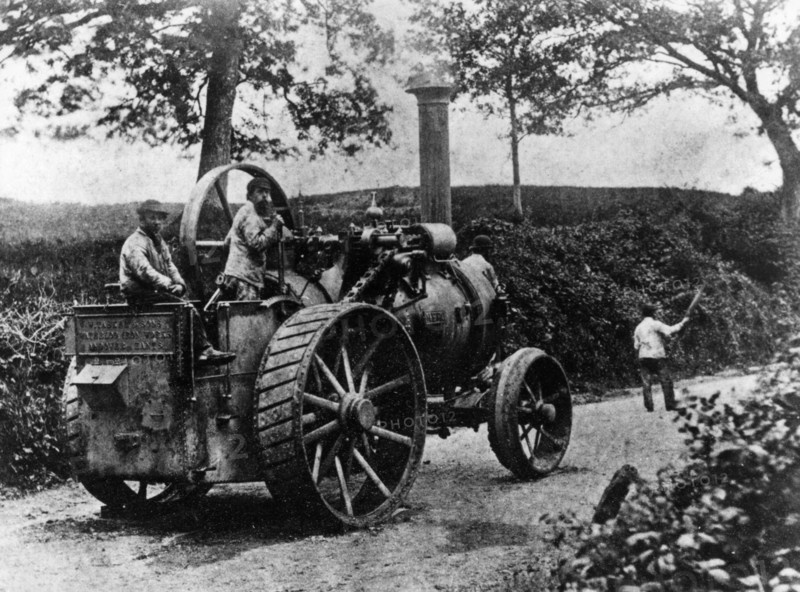 1869 Tasker traction engine with red flag man at the front