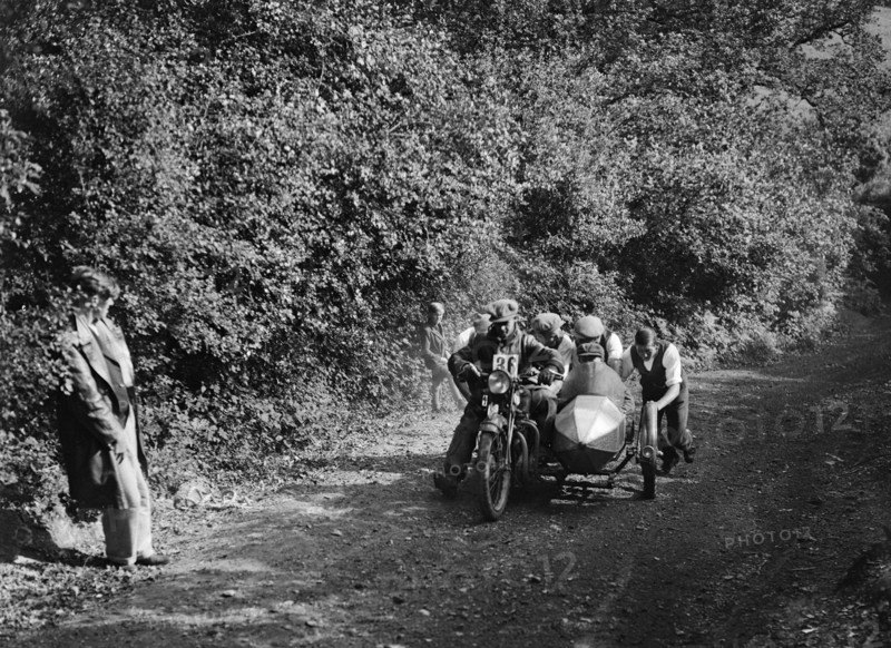 Motorcycle and sidecar competing in the Brighton and Hove Motor Club Brighton-Beer Trial, 1930. Artist: Bill Brunell.
