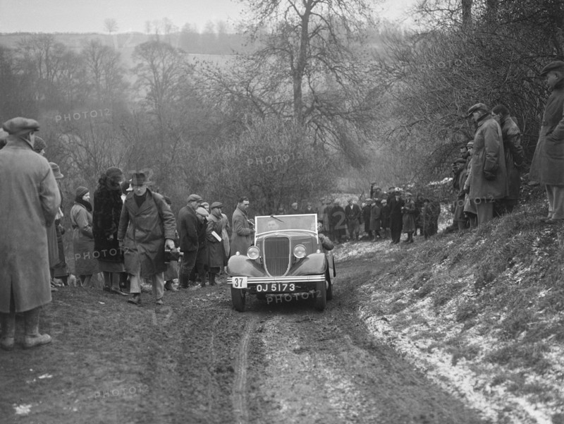 Ford V8 open tourer of H Hillcoat competing at the Sunbac Colmore Trial, Gloucestershire, 1933. Artist: Bill Brunell.