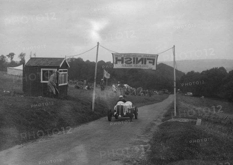 Car crossing the finishing line at the MAC Shelsley Walsh Speed Hill Climb, Worcestershire, 1935. Artist: Bill Brunell.