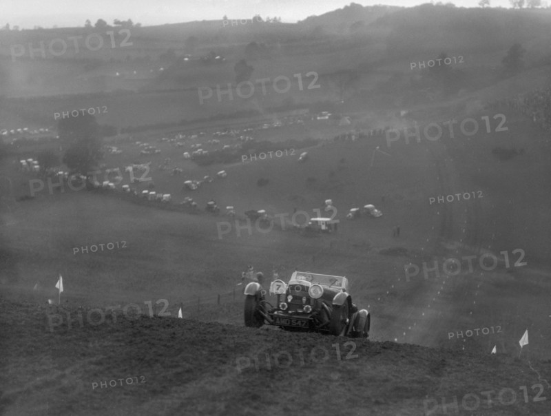 Aston Martin competing in the MG Car Club Rushmere Hillclimb, Shropshire, 1935. Artist: Bill Brunell.