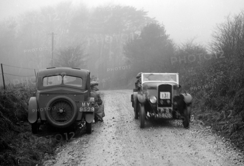 Triumph of J Cramer-Parry passing an official's Riley, MCC Exeter Trial, Blackhill, Dorset, 1930. Artist: Bill Brunell.