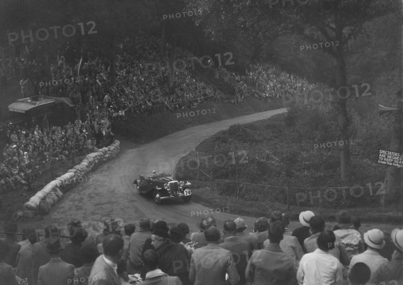 Unidentified open 4-seater car competing in the Shelsley Walsh Hillclimb, Worcestershire, 1935. Artist: Bill Brunell.