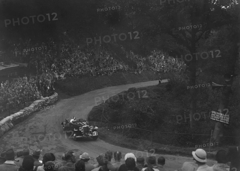 Unidentified open 4-seater car competing in the Shelsley Walsh Hillclimb, Worcestershire, 1935. Artist: Bill Brunell.