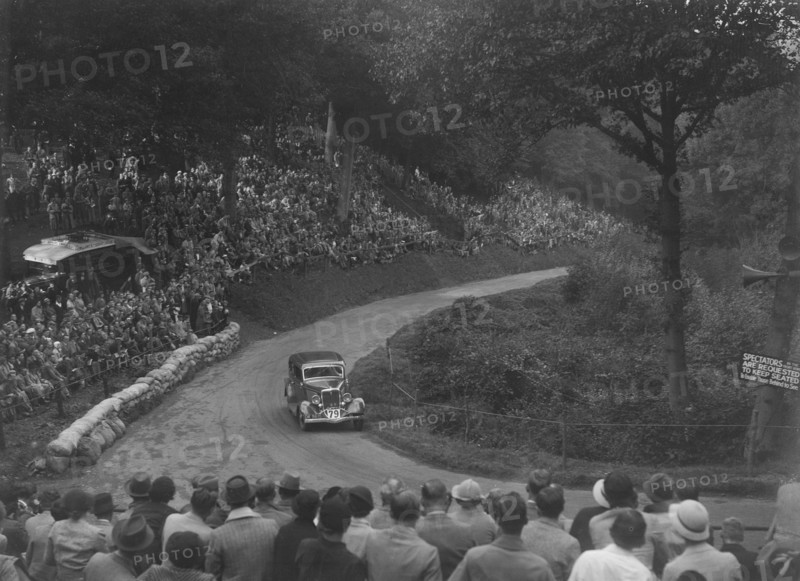 Ford V8 saloon competing in the Shelsley Walsh Hillclimb, Worcestershire, 1935. Artist: Bill Brunell.