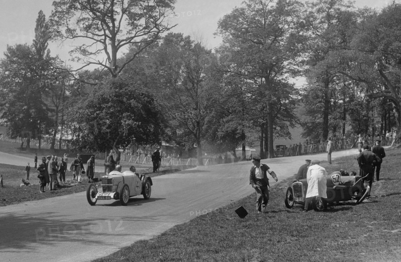 MG J2 passing the crashed Austin 7 of B Sparrow, Donington Park Race Meeting, Leicestershire, 1933. Artist: Bill Brunell.