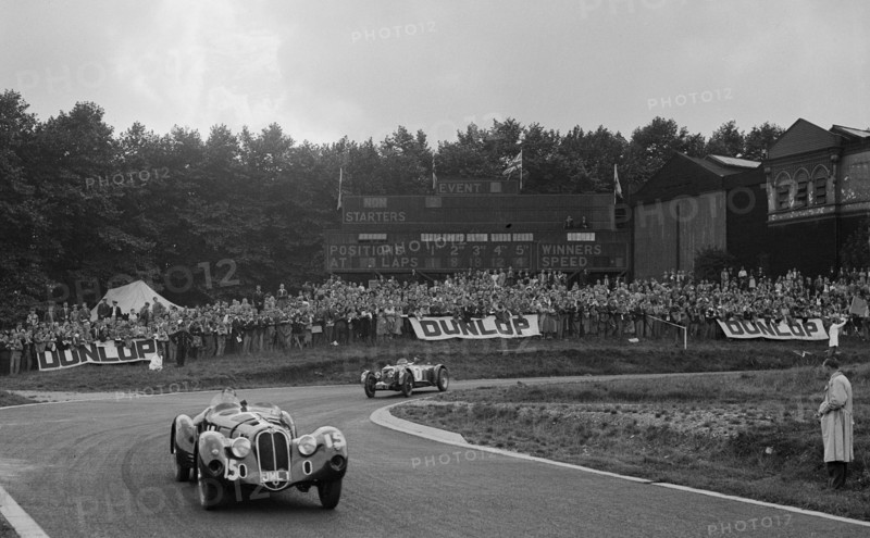 Alfa Romeo of Hugh Hunter leading a Riley at Crystal Palace, London, 1939. Artist: Bill Brunell.