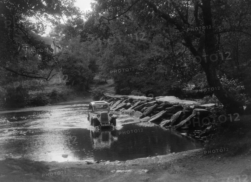 Singer 9 coupe competing in the Mid Surrey AC Barnstaple Trial, Tarr Steps, Exmoor, 1934. Artist: Bill Brunell.