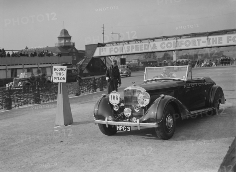 Bentley 4-seater tourer of GG Wood competing in the JCC Rally, Brooklands, Surrey, 1939. Artist: Bill Brunell.
