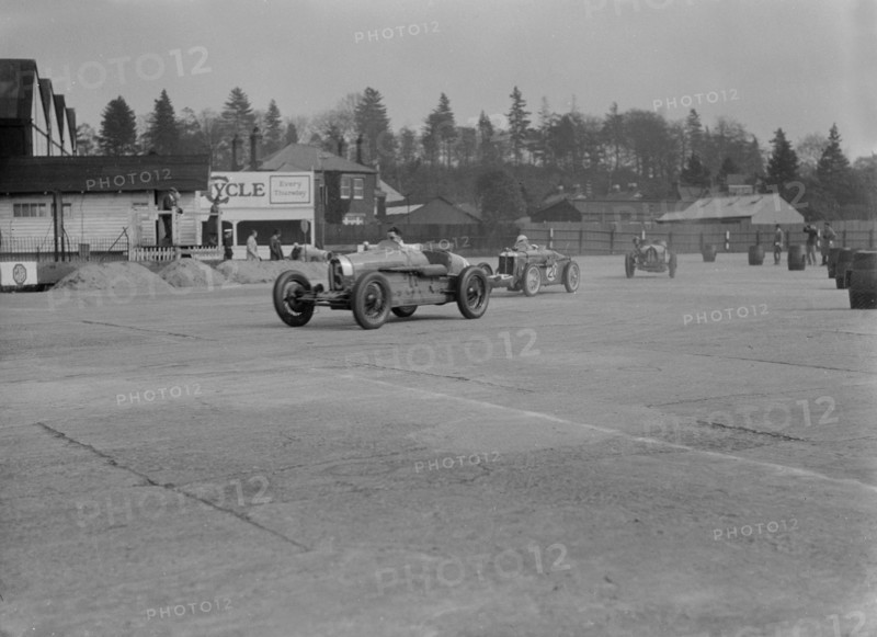 Two Bugatti Type 37s and an MG racing at Brooklands, Surrey, 1930s. Artist: Bill Brunell.