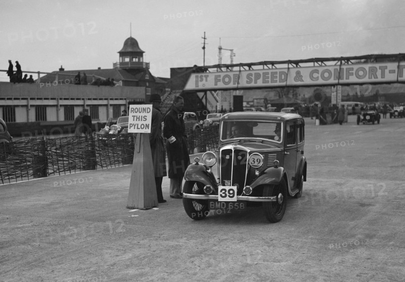 Standard Nine saloon competing in the JCC Rally, Brooklands, Surrey, 1939. Artist: Bill Brunell.