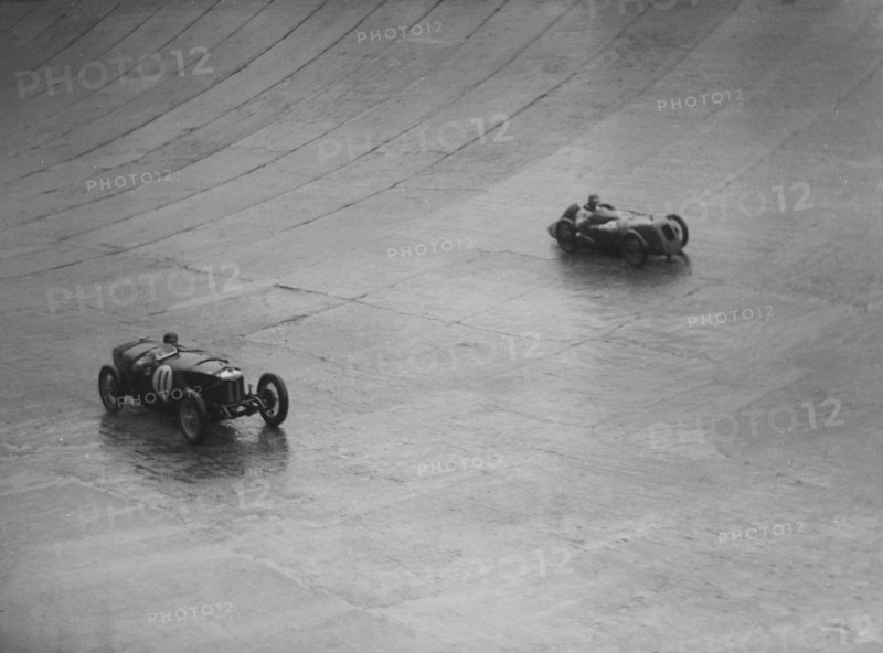 Riley 9 Brooklands and Austin 7 racing at a BARC meeting, Brooklands, Surrey, 1931 Artist: Bill Brunell.