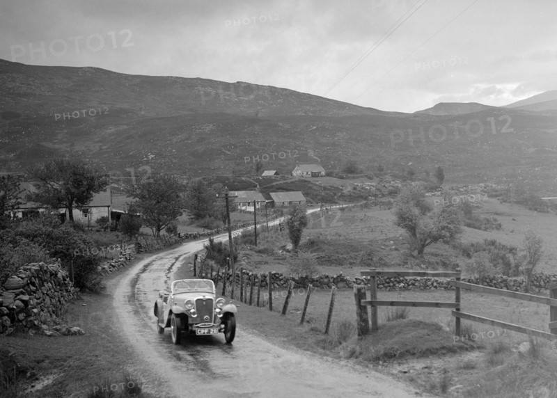 Singer Nine Sports of Miss MC Sherer competing in the RSAC Scottish Rally, 1936. Artist: Bill Brunell.