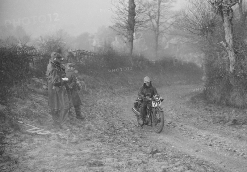 Woman riding a Royal Enfield motorcycle in the Gloucester Trial, c1930s. Artist: Bill Brunell.