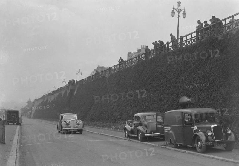 Daimler of CM Simpson and a Morris loudspeaker van on Madeira Drive, Brighton, RAC Rally, 1939. Artist: Bill Brunell.